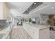 Open-concept kitchen with an eat-in island bar flowing into the living room at 605 Cornwell On The Gulf, Venice, FL 34285