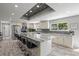 Spacious kitchen featuring a large island, stainless steel appliances, and stylish backsplash at 605 Cornwell On The Gulf, Venice, FL 34285