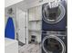 Efficient laundry area with stacked washer and dryer and ample storage at 605 Cornwell On The Gulf, Venice, FL 34285