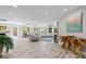 Bright, open living area with tile floors, modern furniture, and large windows for natural light at 605 Cornwell On The Gulf, Venice, FL 34285