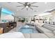 Spacious living area featuring open design, modern decor, and a large television for entertainment at 605 Cornwell On The Gulf, Venice, FL 34285