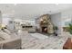 Inviting living room featuring a stone fireplace and open access to the kitchen at 605 Cornwell On The Gulf, Venice, FL 34285
