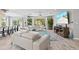 Open-concept living area with comfortable couches, tile flooring, and access to the backyard at 605 Cornwell On The Gulf, Venice, FL 34285