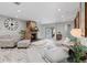 Cozy living room with a stone fireplace, plush seating, and natural light at 605 Cornwell On The Gulf, Venice, FL 34285