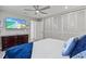 Neutral tone main bedroom featuring gray carpet, tv, and closet at 605 Cornwell On The Gulf, Venice, FL 34285