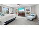 Bright main bedroom with beach view television, ceiling fan, and light-filled windows at 605 Cornwell On The Gulf, Venice, FL 34285