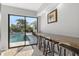 View of the pool and outdoor area from the interior bar with granite countertop at 605 Cornwell On The Gulf, Venice, FL 34285