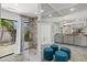 Large walk-in shower with stone tile and glass enclosure, and a view to the exterior at 605 Cornwell On The Gulf, Venice, FL 34285