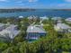 Stunning aerial view of waterfront homes with lush tropical landscaping and private pools in Venice, Florida at 746 Eagle Point Dr, Venice, FL 34285