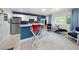 Unique basement with kitchenette, stylish bar seating, and charming nautical decor at 746 Eagle Point Dr, Venice, FL 34285