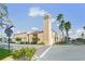 Commercial property with a unique bell tower, complemented by palm trees and beautiful landscaping at 746 Eagle Point Dr, Venice, FL 34285