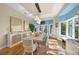 Dining room with modern lighting, stylish furniture, and scenic backyard views at 746 Eagle Point Dr, Venice, FL 34285