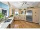 Bright kitchen featuring marble countertops, cabinets and stainless steel refrigerator at 746 Eagle Point Dr, Venice, FL 34285