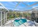 Sparkling screened-in pool with spa and sunning area, perfect for relaxation and recreation at 746 Eagle Point Dr, Venice, FL 34285