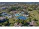 Aerial view of community featuring a pool, tennis courts, and verdant landscaping at 748 White Pine Tree Rd # 208, Venice, FL 34285