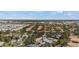 Scenic aerial view of a residential area with tree-lined streets and varied rooftops, showcasing community living at 888 Guild Dr, Venice, FL 34285