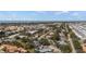 An aerial view captures a charming neighborhood with lush trees, roads, and distant water at 888 Guild Dr, Venice, FL 34285