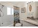 Bright bathroom featuring a tub-shower combo and a stylish granite vanity at 888 Guild Dr, Venice, FL 34285