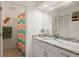 Tastefully decorated bathroom with updated vanity, colorful shower curtain, and decorative accents at 888 Guild Dr, Venice, FL 34285