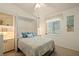 Cozy bedroom showcasing a comfortable bed, a bright window, and a built in bookshelf at 888 Guild Dr, Venice, FL 34285