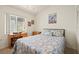 Bedroom featuring a comfortable bed, a bright window, and a wooden desk at 888 Guild Dr, Venice, FL 34285