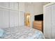 Bedroom featuring a comfortable bed, TV, and multiple closets for storage at 888 Guild Dr, Venice, FL 34285