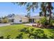 Charming single-story home with a well-manicured lawn, mature trees and attached two-car garage at 888 Guild Dr, Venice, FL 34285
