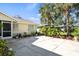 Exterior view of charming home with meticulously landscaped front yard, lush greenery, and concrete driveway at 888 Guild Dr, Venice, FL 34285