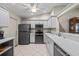 Modern kitchen with gray cabinets, stainless steel appliances, and a tile floor at 888 Guild Dr, Venice, FL 34285