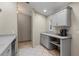 Modern kitchen with gray cabinets, stainless steel appliances, and a tile floor at 888 Guild Dr, Venice, FL 34285