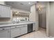 Modern kitchen with gray cabinets, stainless steel appliances, and a tile floor at 888 Guild Dr, Venice, FL 34285