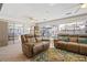 Bright Florida room with sliding glass doors to yard and pool area, and comfortable leather seating at 888 Guild Dr, Venice, FL 34285