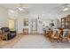 Spacious living room with tile floors, ceiling fans, and a view into the kitchen at 888 Guild Dr, Venice, FL 34285