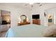 Bright and airy main bedroom leads to a private bathroom and features a large dresser and flat screen tv at 888 Guild Dr, Venice, FL 34285