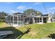 Spacious screened-in pool enclosure in backyard offers the perfect space for outdoor relaxation and entertainment at 888 Guild Dr, Venice, FL 34285