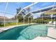 Inviting pool featuring clear water, a screened enclosure, and ample patio space at 888 Guild Dr, Venice, FL 34285