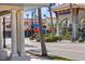 Vibrant street view with charming buildings, lush landscaping, and palm trees at 888 Guild Dr, Venice, FL 34285