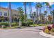 Picturesque street view featuring colorful buildings, lovely landscaping, and swaying palm trees at 888 Guild Dr, Venice, FL 34285