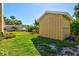 Backyard featuring a shed, green grass, and foliage at 1104 Riviera St, Venice, FL 34285