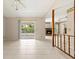 Open living area with tile flooring, ceiling fan, and sliding door access to the screened-in lanai at 1104 Riviera St, Venice, FL 34285