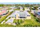 Aerial view of a one story home with a nice yard and a screened in porch at 1104 Riviera St, Venice, FL 34285