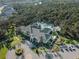 A beautiful community clubhouse with a pool, landscaping, and parking area creates a resort-like experience for residents at 12468 Shimmering Oak Cir, Venice, FL 34293