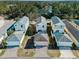 An aerial shot shows homes with well-maintained exteriors, driveways and manicured lawns in a quiet neighborhood at 12468 Shimmering Oak Cir, Venice, FL 34293