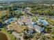 Overhead shot of the community recreational center with playground, water park and sports courts amid lush landscaping at 12468 Shimmering Oak Cir, Venice, FL 34293