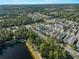 Overhead perspective reveals a well planned community with mature trees, tidy homes, and a tranquil lake at 12468 Shimmering Oak Cir, Venice, FL 34293