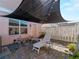 Backyard patio area with overhead shade covering and a lounge chair at 12468 Shimmering Oak Cir, Venice, FL 34293