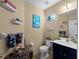 Charming bathroom with nautical decor, vanity, and themed accessories at 12468 Shimmering Oak Cir, Venice, FL 34293