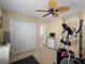 Bedroom featuring a closet, a ceiling fan, with a connecting office and bath at 12468 Shimmering Oak Cir, Venice, FL 34293