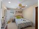 Bedroom featuring a ceiling fan, a patterned bedspread, and bright yellow walls at 12468 Shimmering Oak Cir, Venice, FL 34293