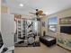 Bedroom featuring an exercise machine, cabinets, window, and a ceiling fan at 12468 Shimmering Oak Cir, Venice, FL 34293